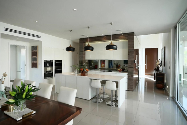 A contemporary kitchen and dining area featuring a spacious dining table.